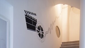 A staircase with a handrail, a wall-mounted light fixture, and a door at the top. - B&B Turin Très Chic. In the historic center with its own entrance (Torino)