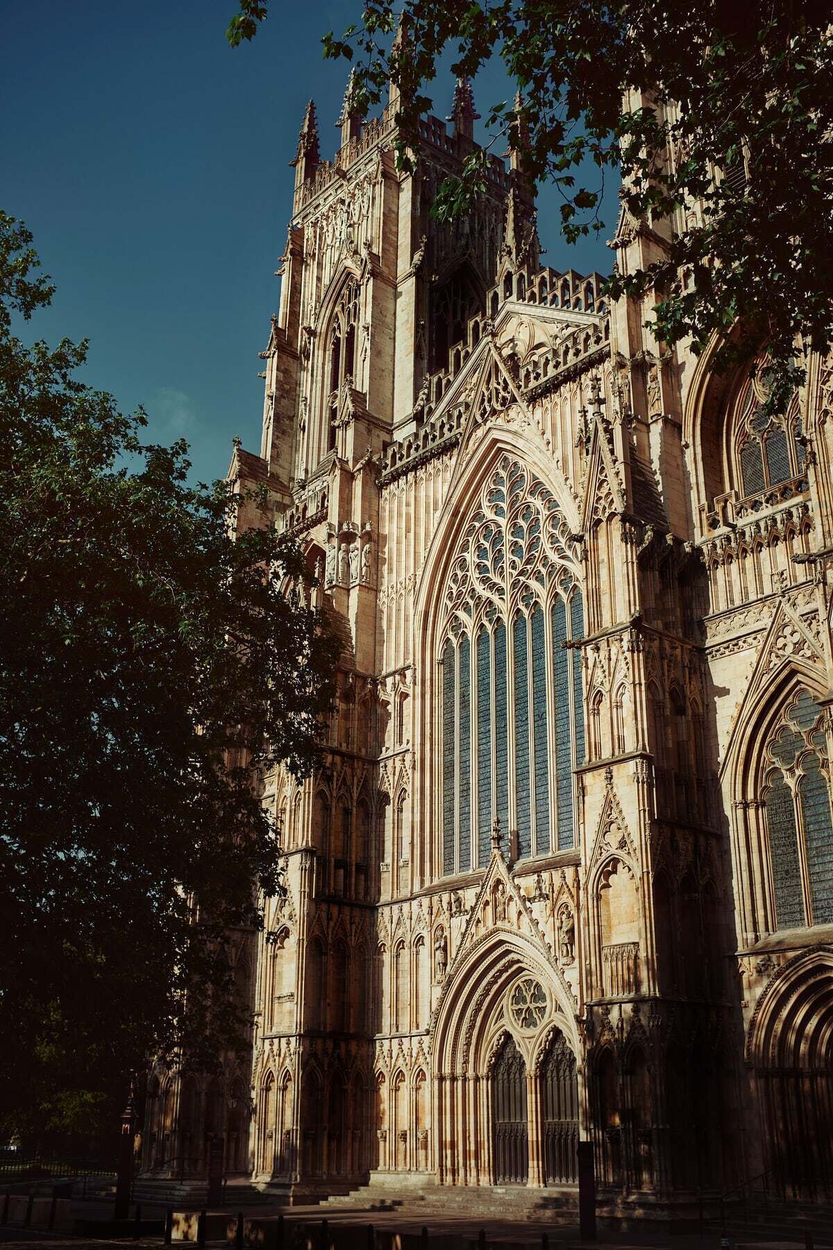 A Gothic-style cathedral with intricate stonework, large stained glass windows, and a prominent entrance.