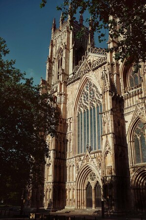 A Gothic-style cathedral with intricate stonework, large stained glass windows, and a prominent entrance.