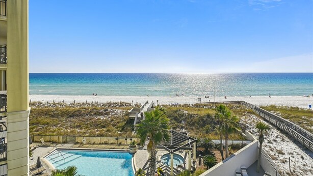 A pool area with a view of the beach and ocean. - Seacrest 501AB is a Gulf Front 3 BR on Okaloosa Island by RedAwning (Fort Walton Beach)