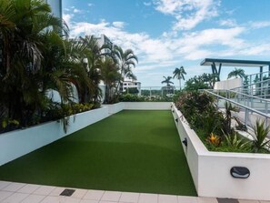 Enjoy the serene rooftop garden with lush greenery and a tranquil atmosphere.