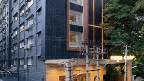 A modern building with a prominent 'Morex Group' sign, featuring a large vertical window and a well-lit entrance. - Lazdana Hotel Bangalore (Bengaluru)