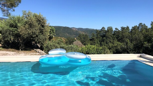 A clear blue pool with inflatable rings floating on the surface. - Olive Grove Villa, private pool & whirl pool, total privacy (Marmaris)