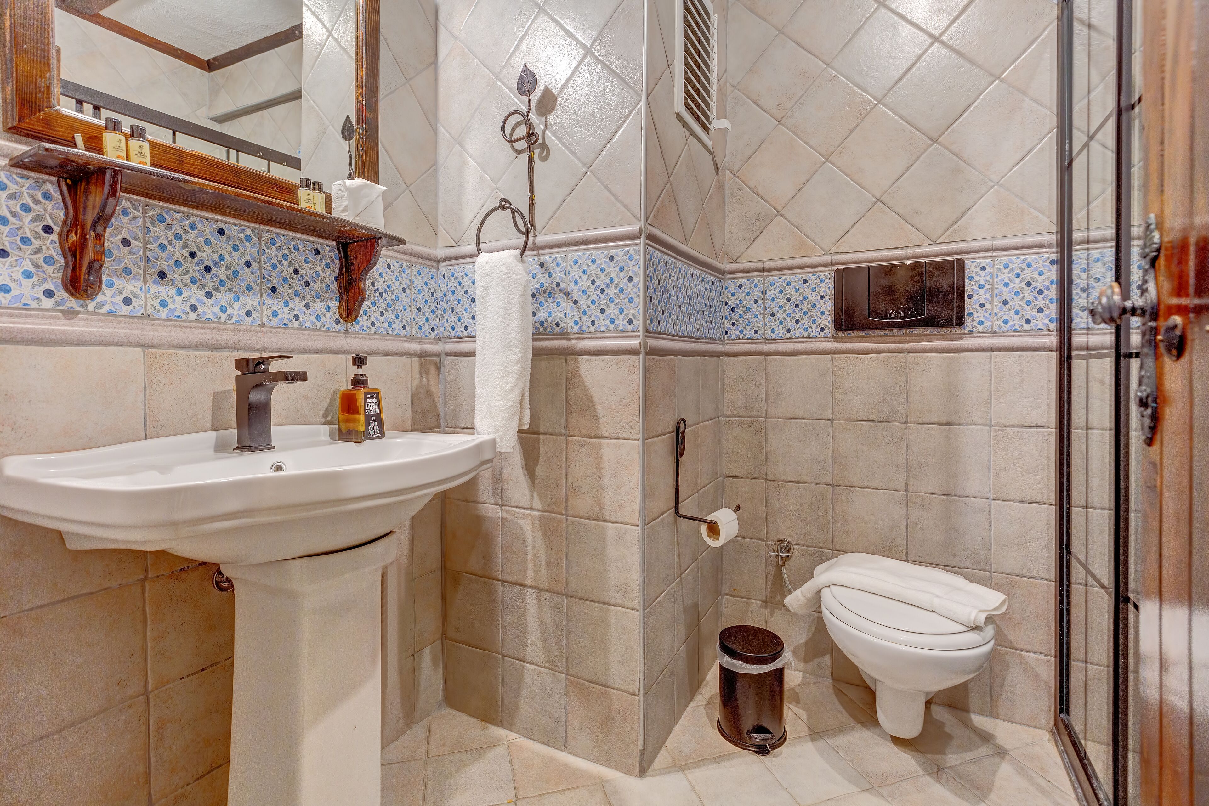 A bathroom with a sink, toilet, and shower area.