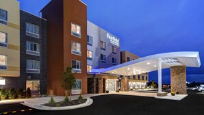 A multi-story hotel with a prominent "Fairfield" sign, a covered entrance, and a parking area. - Fairfield Inn & Suites by Marriott Grand Rapids Wyoming (Wyoming)