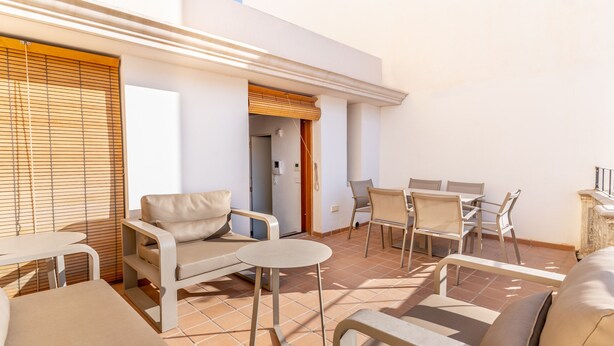 A sunlit outdoor patio with a sofa, chairs, and a small table. - New duplex in Ibiza center with Dalt Vila views (Ibiza)