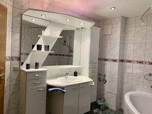 Bathtub, hair dryer, towels, soap
