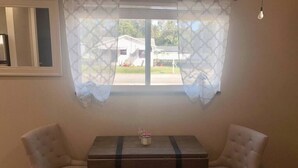 A room with a window, two chairs, a small table, and a light bulb. - "The Sweet Suite" - Private & Quiet, Near 408/417 (Orlando)
