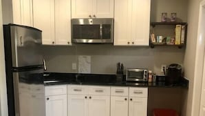 A kitchen with white cabinets, a stainless steel refrigerator, a microwave, and a toaster. - "The Sweet Suite" - Private & Quiet, Near 408/417 (Orlando)