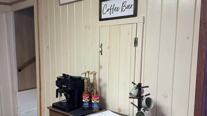 A coffee bar area with a coffee machine, Torani syrup bottles, and a sign that reads "Coffee Bar".
