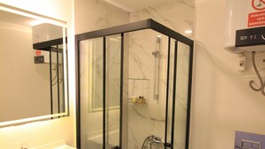 A modern bathroom with a glass-enclosed shower, a white sink, and a toilet. - YALIN APART HOTEL (Bodrum)