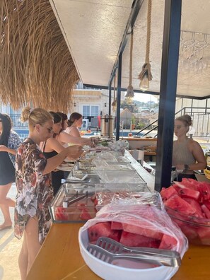 A buffet setup with various food items and utensils. - Sole'n Blu Hotel (Kas)