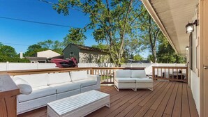 A covered outdoor deck with white furniture, including sofas and a coffee table. - ★Dragon’s Lair★Private Home w/ Arcade & Minigolf★ (Westerville)