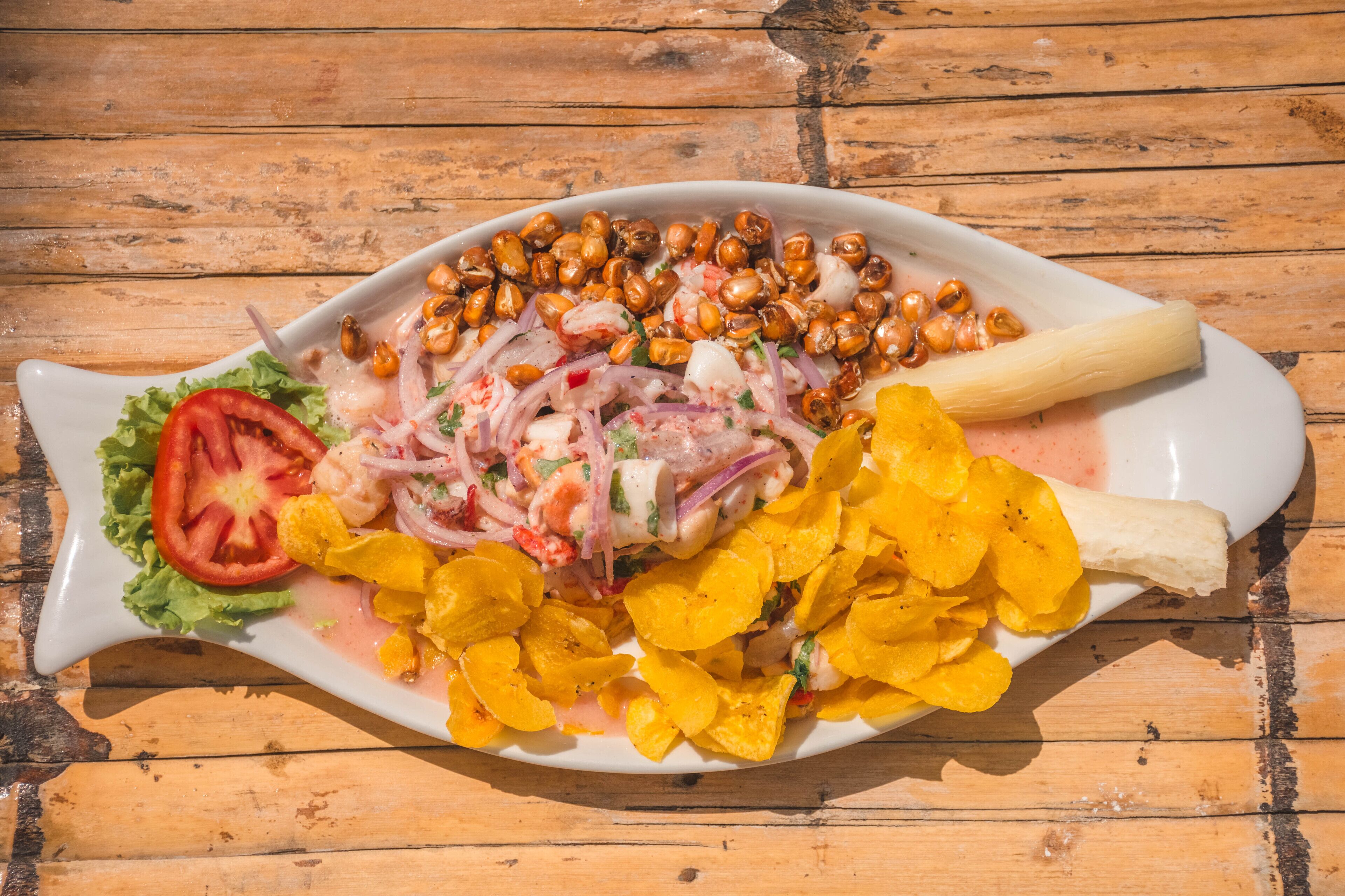 A seafood dish on a white plate with a wooden table background.