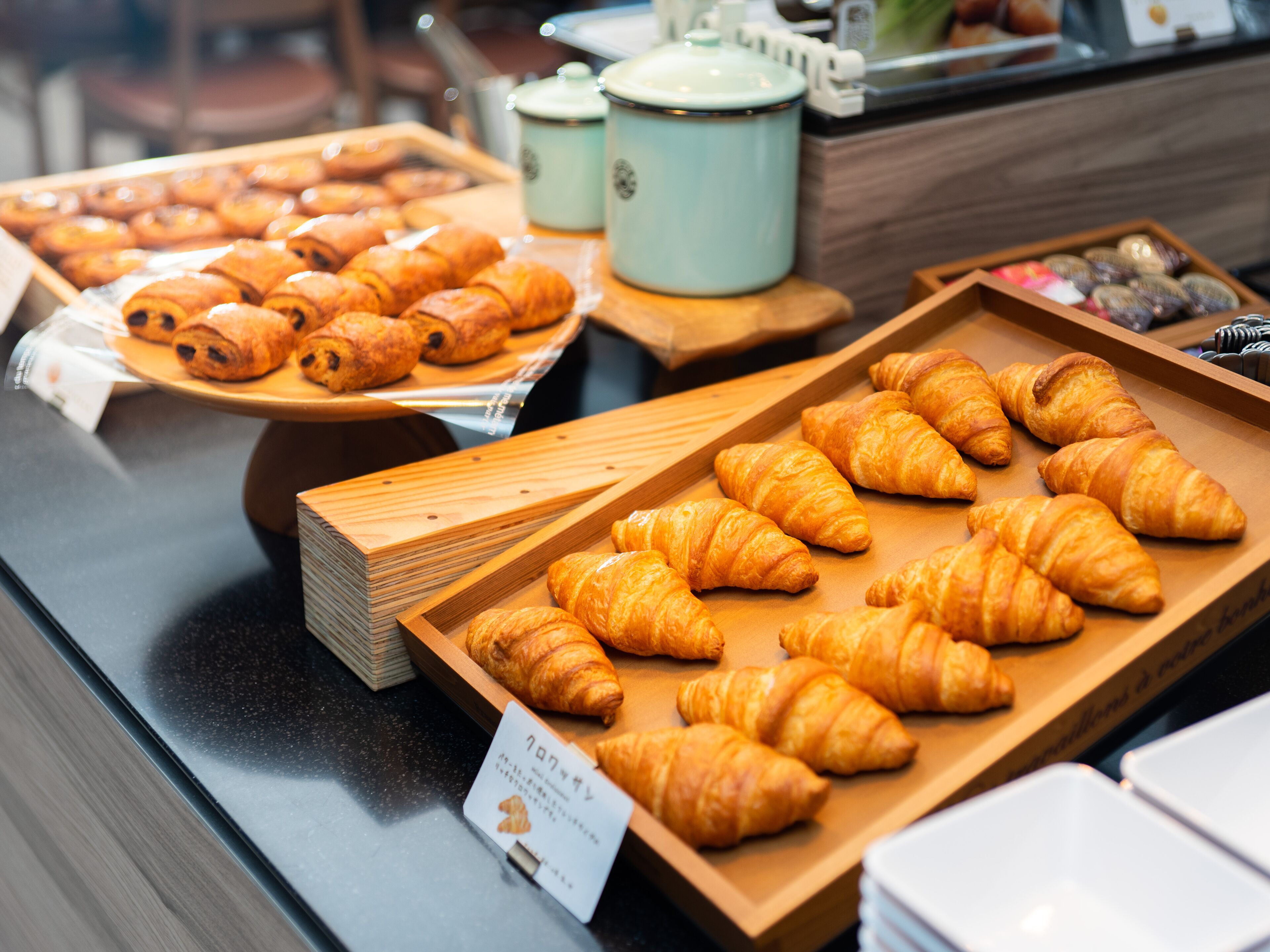 A bakery display with various types of pastries and bread.