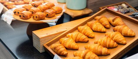 A bakery display with various types of pastries and bread.