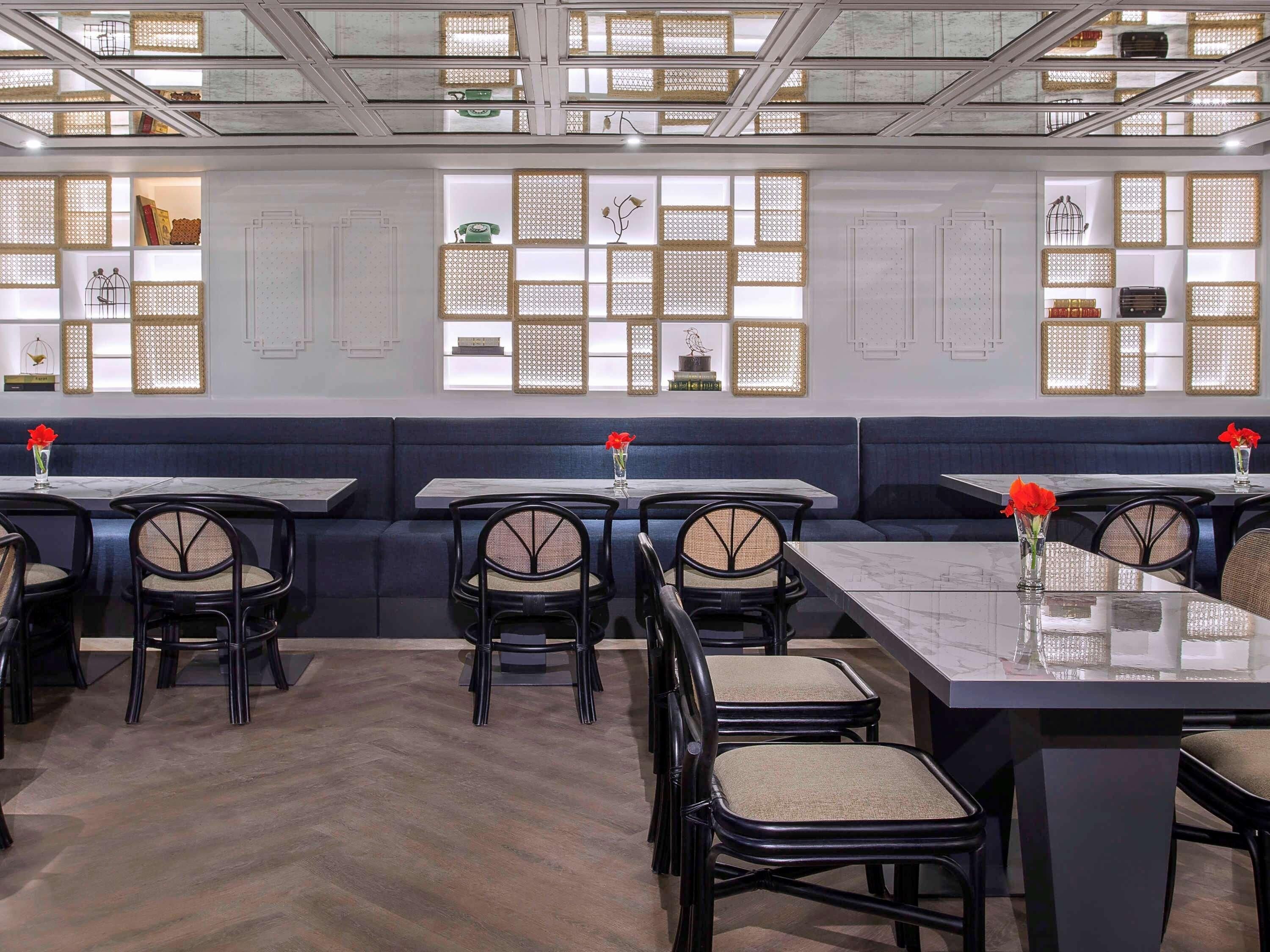 A restaurant interior with booths, tables, and chairs.