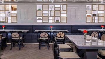 A restaurant interior with booths, tables, and chairs.
