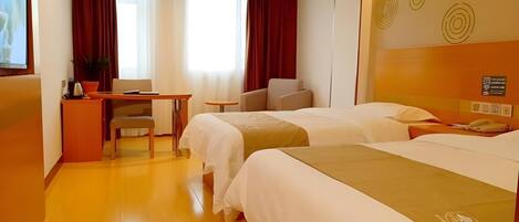 A hotel room with two beds, a desk, a chair, a TV, and a potted plant.