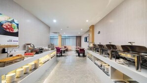 A buffet setup with multiple serving stations and a long counter displaying various dishes. - Lavande Hotel (Guilin Longsheng) (Longsheng)