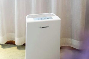 A white Fusewins portable heater in a room with a white curtain backdrop. - Lavande Hotel (Guilin Longsheng) (Longsheng)
