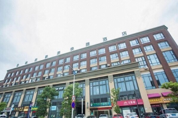 A multi-story commercial building with large windows and multiple storefronts. - Greentree Inn (Zhoushan Baiquan Binfen Square) (Zhoushan)