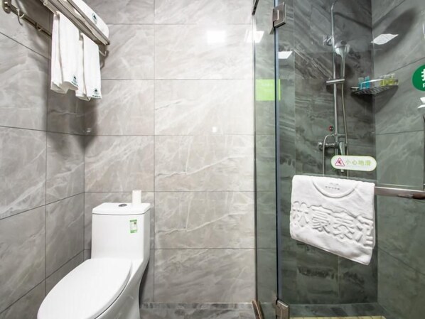 A bathroom with a toilet, a glass shower enclosure, and a towel rack. - Greentree Inn Yinchuan International Trade Market (Yinchuan)
