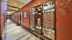A corridor with patterned walls, decorative screens, and a tiled floor. - Dongshan Hotel, Guangzhou (Guangzhou)