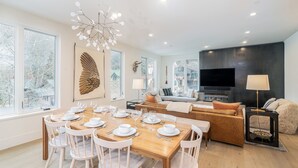 A modern living room with a large flat-screen TV, a fireplace, and a cozy seating area. - SAN JUAN 103- Newly-Built, Masterfully Finished Jewel near Gondola, Shops, Resta (Telluride)