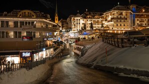 A snow-covered street with buildings, including a hotel named 'Christine' and a restaurant 'Brundl'. - Hotel Abendrot by Alpeffect Hotels (Ischgl)
