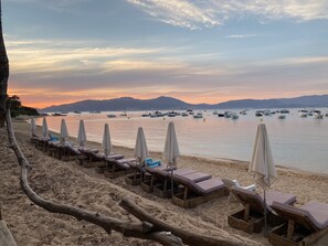 On the beach, sun-loungers