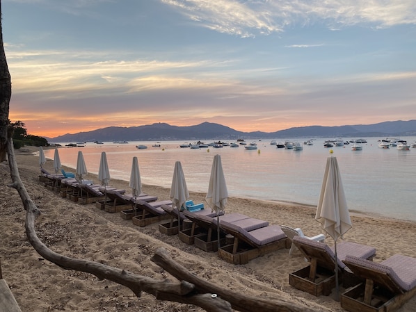 On the beach, sun loungers