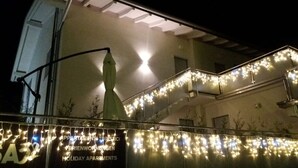 A building with holiday decorations and a sign for 'Holiday Apartments'. - 32 GARDEN HOUSE (Nago-Torbole)