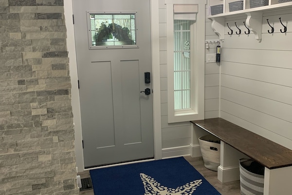 Front entryway bench with hooks for coats.