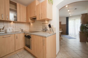 Apartment, 1 Bedroom (Enzian) | Private kitchen | Full-size fridge, oven, stovetop, dishwasher - Stembergerhof (Lesachtal)