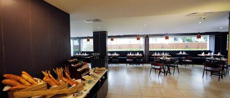 A buffet setup with various food items and seating arrangements.