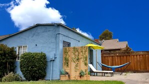 A blue house with a wooden fence, a hammock, and a yellow umbrella. - Large Private Oasis with Yard Space, Minutes to Downtown (San Jose)