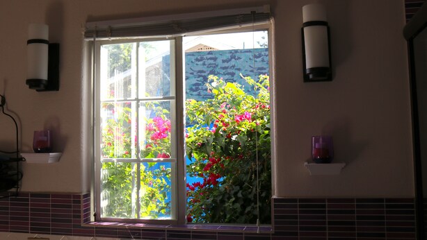 A kitchen with a window, a white countertop, and a backsplash. - Large Private Oasis with Yard Space, Minutes to Downtown (San Jose)