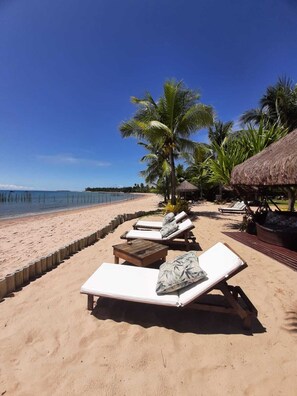 On the beach, sun-loungers, beach bar