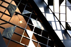 A geometric metal structure with a hanging light fixture.