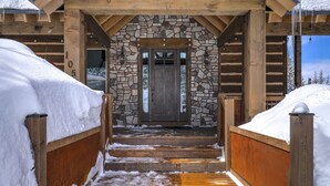 A wooden cabin entrance with a stone wall, wooden steps, and a door. - Cozy Brian Head Cabin Near Ski Resorts, Bike Trails, and National Forests (Brian Head)
