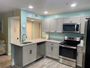 Enjoy cooking in this well-equipped kitchen with a granite countertop, stainless steel appliances, and a dishwasher.