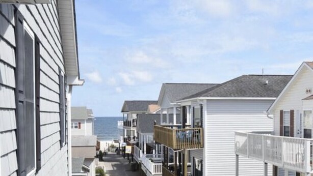 A coastal street with beachfront properties, including balconies and a view of the ocean. - Beautiful Oceanview House in Ocean Lakes (Myrtle Beach)