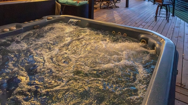 A hot tub on a wooden deck with string lights overhead. - Lake Travis Lakefront with Hot Tub, Private Boat Dock & Lakeside Parks (Lago Vista)