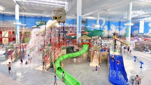 An indoor water park with slides, water features, and play structures. - Lake Travis Lakefront with Hot Tub, Private Boat Dock & Lakeside Parks (Lago Vista)
