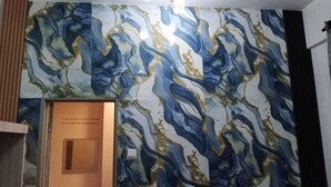 A room with a marble-patterned wall and a wooden door.