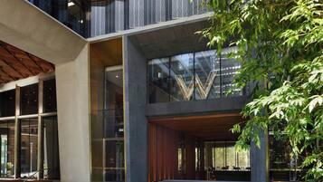 A modern building with large windows, a wooden facade, and a visible 'W' logo.
