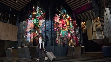 A modern interior with a large digital display featuring colorful abstract art.