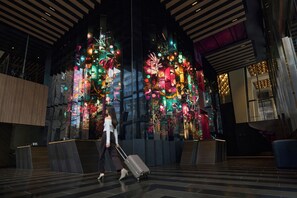 A modern interior with a large digital display featuring colorful abstract art. - W Melbourne (Melbourne)