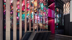 A modern interior with a vibrant, abstract mural on the wall, a staircase, and a mix of dark and light flooring. - W Melbourne (Melbourne)